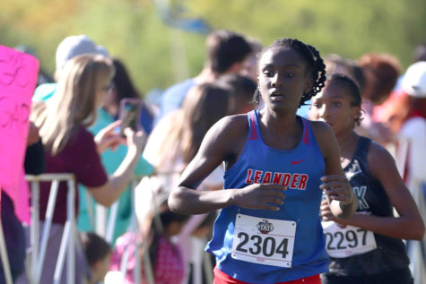 Junior Jaya Coast crossing the finish line at her UIL state cross country meet placing 36th out of 149 contestants with a time of 19:33.
