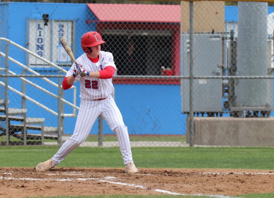 Sophomore Colbin Holmes swings the bat at the March 14 game against Rouse