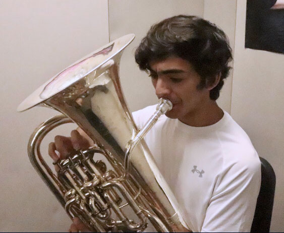 Gustavo Perez practices his music for regional band auditions, undisturbed within the quiet of the band program's practice rooms. "Times like this allow us to work [individually] so  that we re better prepared for the upcoming auditions."