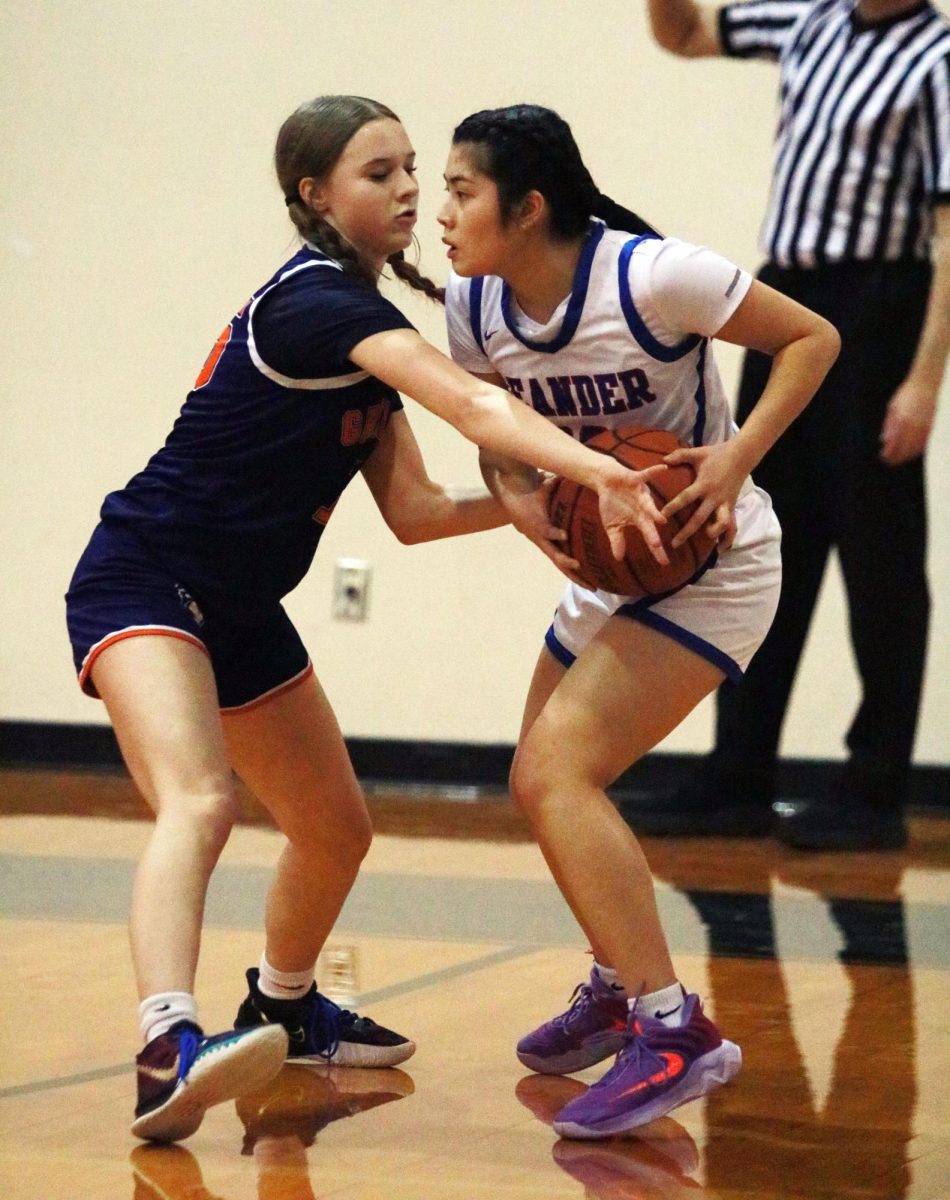 Junior Varsity player Myky Ho grapples with her Glen opponent for control of the ball, prepared to pass it onto her teammates.. "Teamwork is important to me because I believe it’s the key to succeeding in basketball," Ho said. "No matter how fast you dribble, you’re never faster than a pass. Not to mention it’s just more fun when you work as a team knowing you have people by your side. "