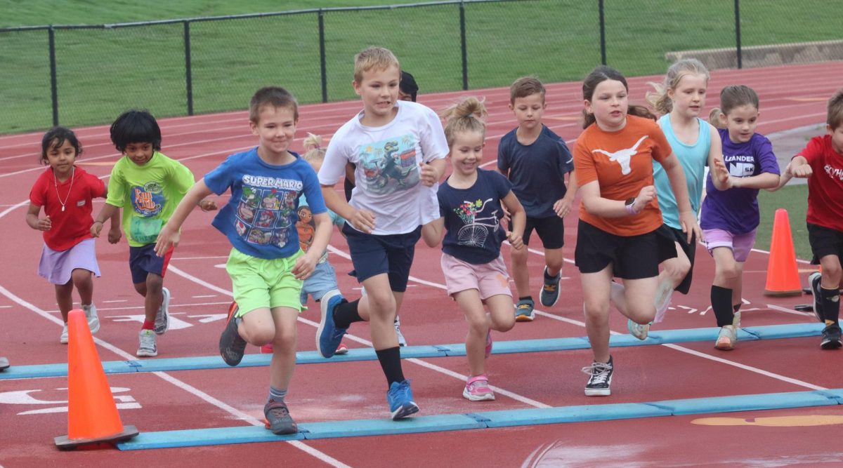 Kids K starts as kids fly across the start line marker on April 26. 