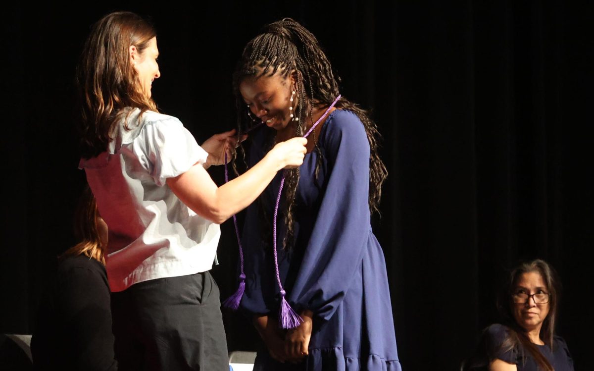 Senior Sepria Doherty receiving dual credit cord by Megan Wolske during Senior Awards ceremony on 5 14 2025 Marilyn Rutschman