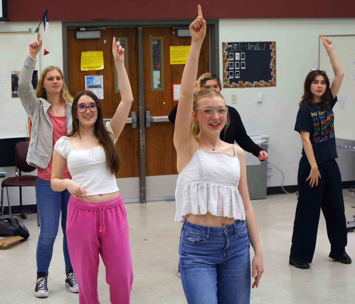 Jordan Vestal, sophomore, Jillian Fowler, junior, Evyn Kidd, junior, Sabrina Erixon, junior prepare for the annual choir pop showcase  during class on May 9 by learning the accompanying dances.
