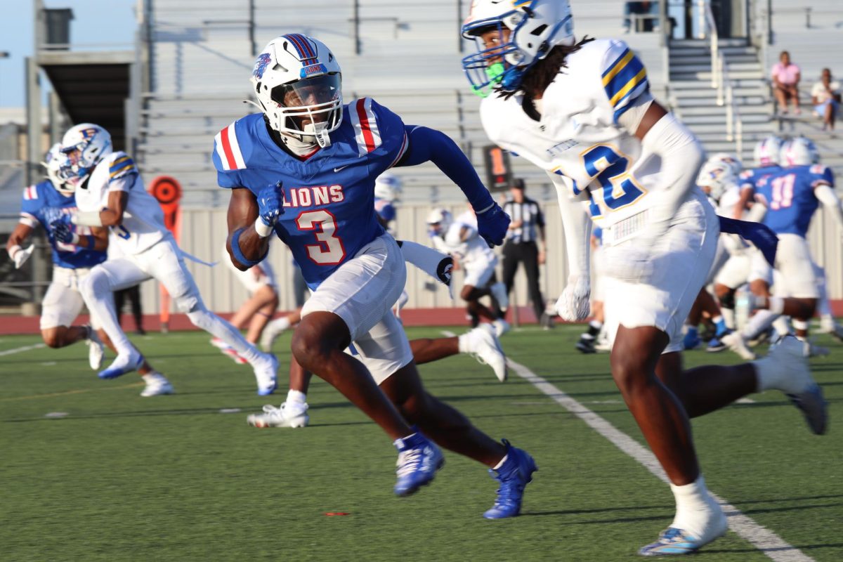 Defensive back Tyree Smith churns turf to cut off Pflugerville player.  