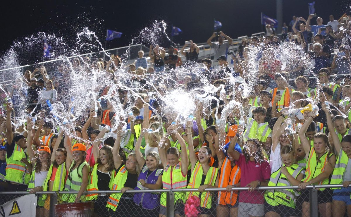 The student section throws water during the stand tune 'Tear it Up'. 