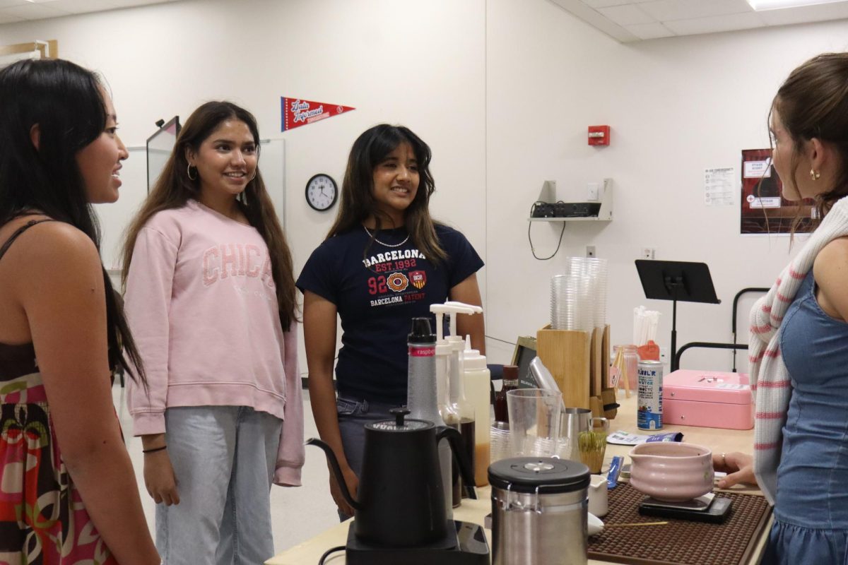 Club Presidents Senior President Srinija Chukkapalli, Senior Hasini Mandava, and Senior Lizzy Hui talking to Alumni Ava Herron before the Girlhood/Women in STEM/Women in Business meeting in Lecture Hall C on Sept. 10. 