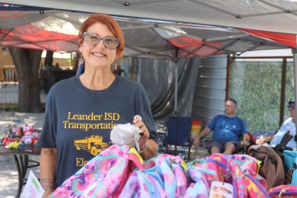 Felicia Whaley welcomes those impacted by the July 4 floods with a smile to her backpack drive organized at Nameless Saloon.