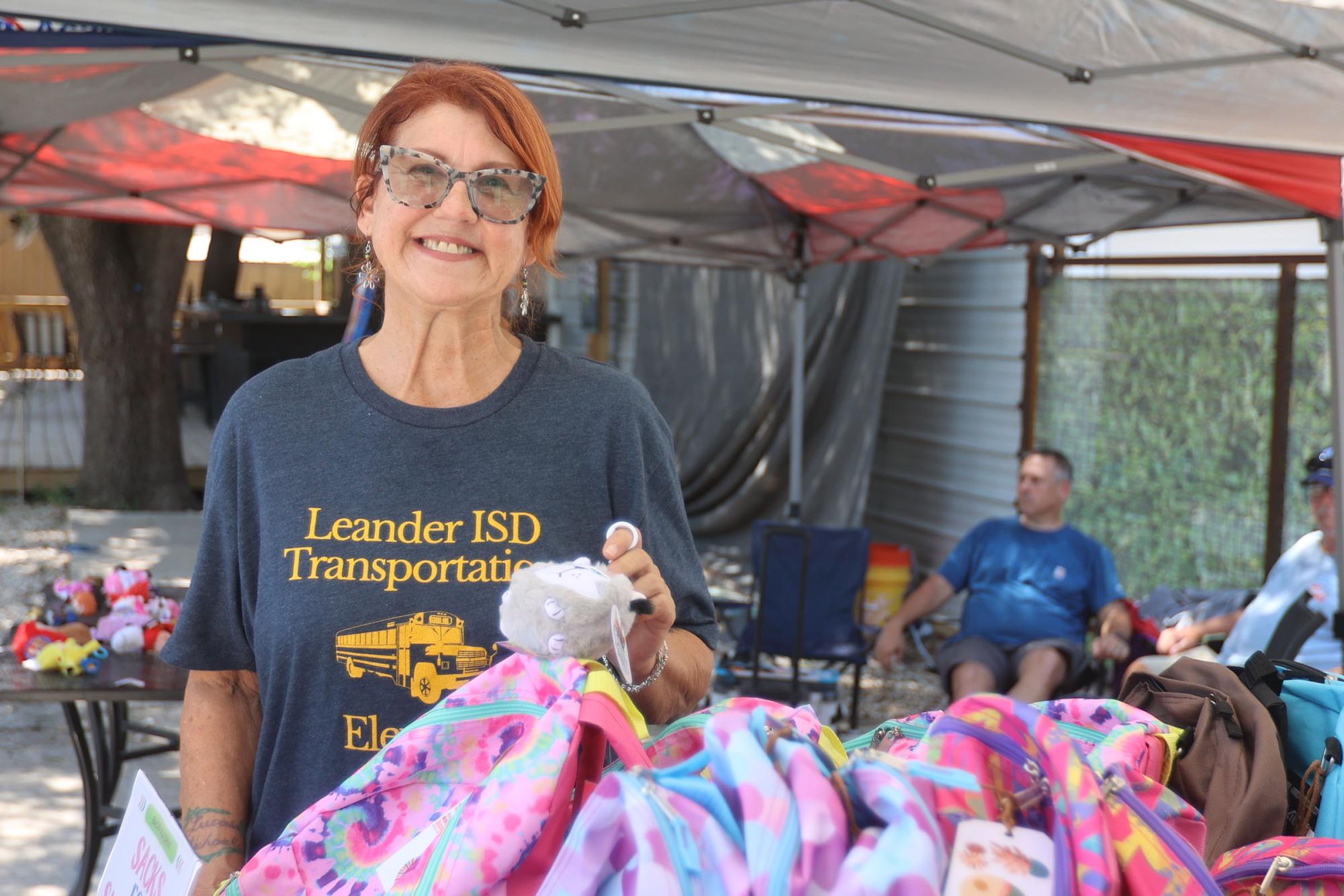 Felicia Whaley welcomes those impacted by the July 4 floods with a smile to her backpack drive organized at Nameless Saloon.