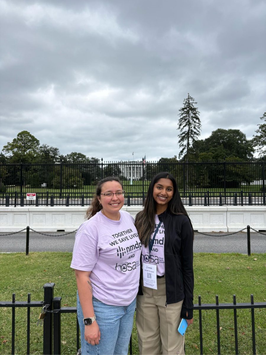 Senior Aditi Busa poses with health science teacher Alexus Guerra.