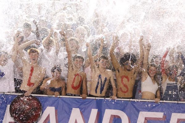 As tradition during every football game, student section fans lift water bottles and soak the crowd.