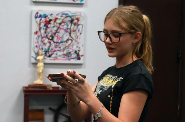 Junior Thienn Peterson directs vocal warm-ups, playing scales from her phone to begin. This, along with determining the correct vocal range of each actor and harmonic arrangement, is one of several assignments Peterson assumed as the show's musical director.