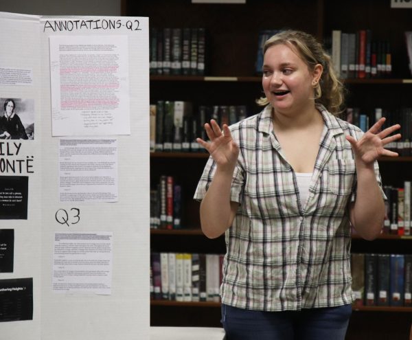 Senior Emma Funes walks her AP Literature class through guiding questions posed by Emily Bronte's "Wuthering Heights." Funes' group explored the cyclical nature of revenge and the exploration of manhood in Bronte's classic novel.