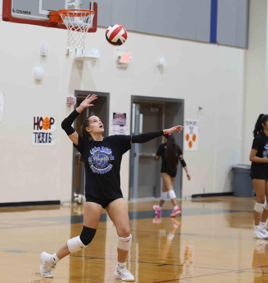 Senior Addison Cooper plays in the senior faculty volleyball game in the new competition gym on Dec. 19. "A win is a win. I am so grateful I got to play with my teammates one last time and beat our coach who was on the faculty team,"  Cooper said.