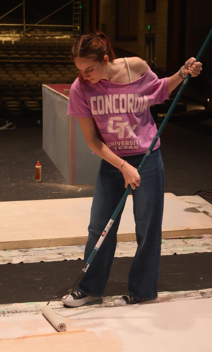 During 7th period junior Mary Shammas paints props for "Singing in the Rain". Shammas said, "the most challenging has been finding motivation when those around me are not helping. It's hard to have energy when others are lifeless." 