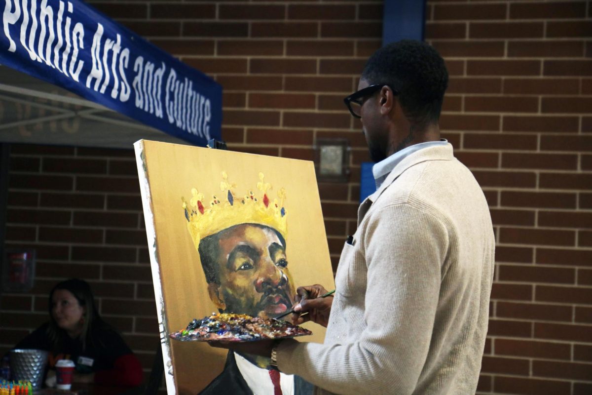 Austin painter Xavier Alvarado delicately depicts Martin Luther King Jr. in a live painting, which was auctioned off through a raffle. Alvarado has painted for previous MLK festivals and Leander's annual Juneteenth event.