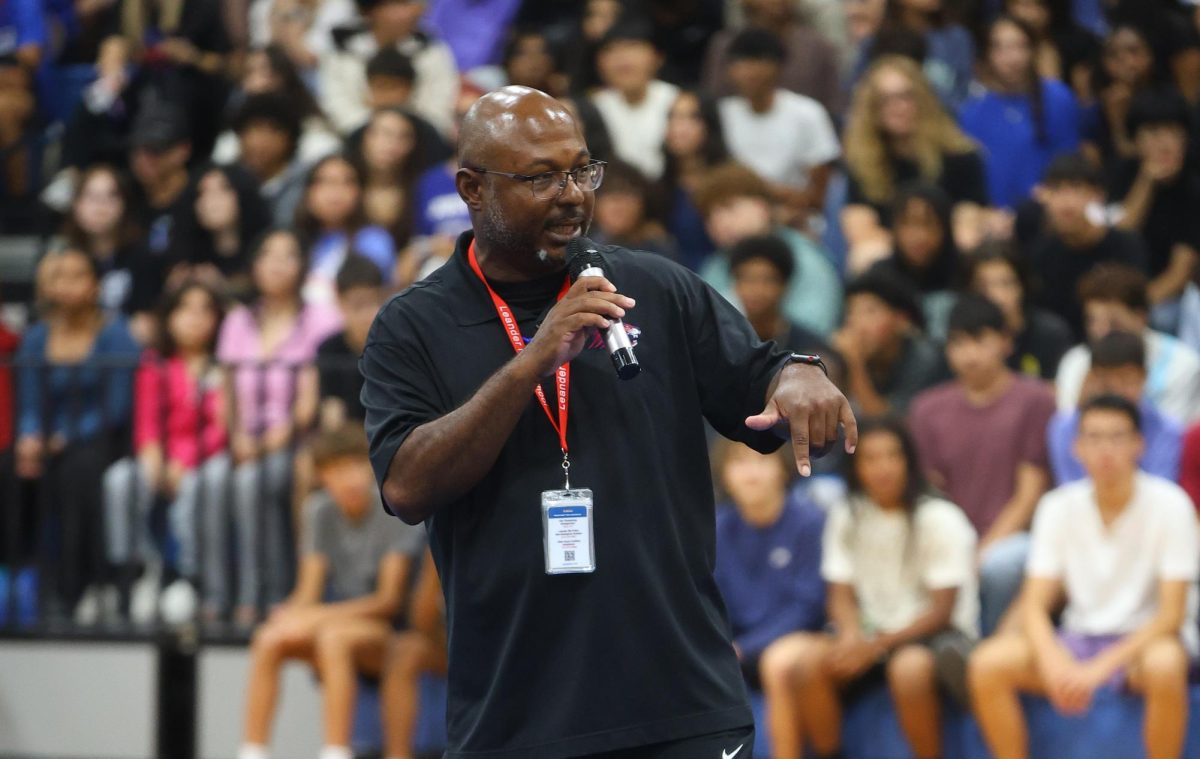 Head athletic coordinator Kris Price hypes up the crowd in a speech given at the Homecoming pep rally on Oct. 3. Before moving to Leander in 2019, he served as the defensive coordinator at Keller High School. 