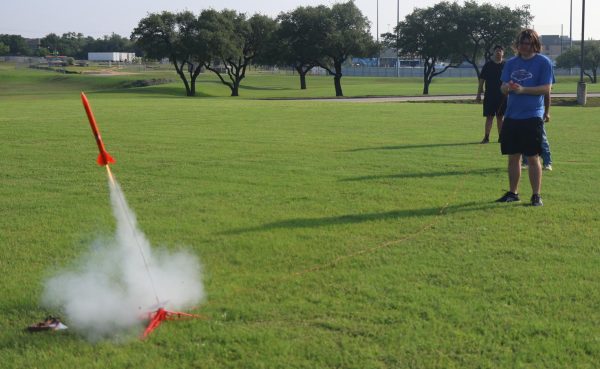 Mercapto Mcfay launches his rocket that at the field behind the tennis courts. To launch the rocket, students had to attach an electric starter and put a key into the remote. Mcfays rocket went 81 meters.