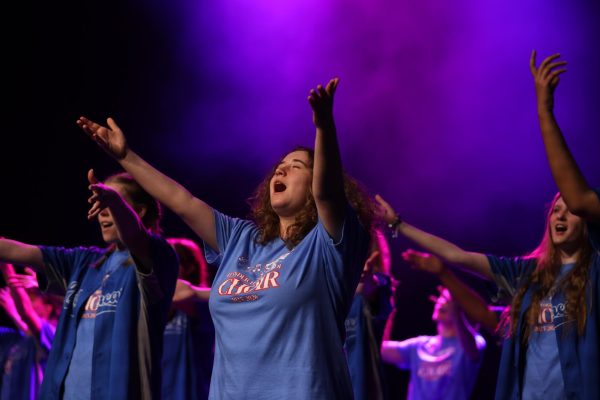 Junior Soliluz Nievas reaches to the purple spot lit ceiling during Lionheart's rendition of "Bohemian Rhapsody."