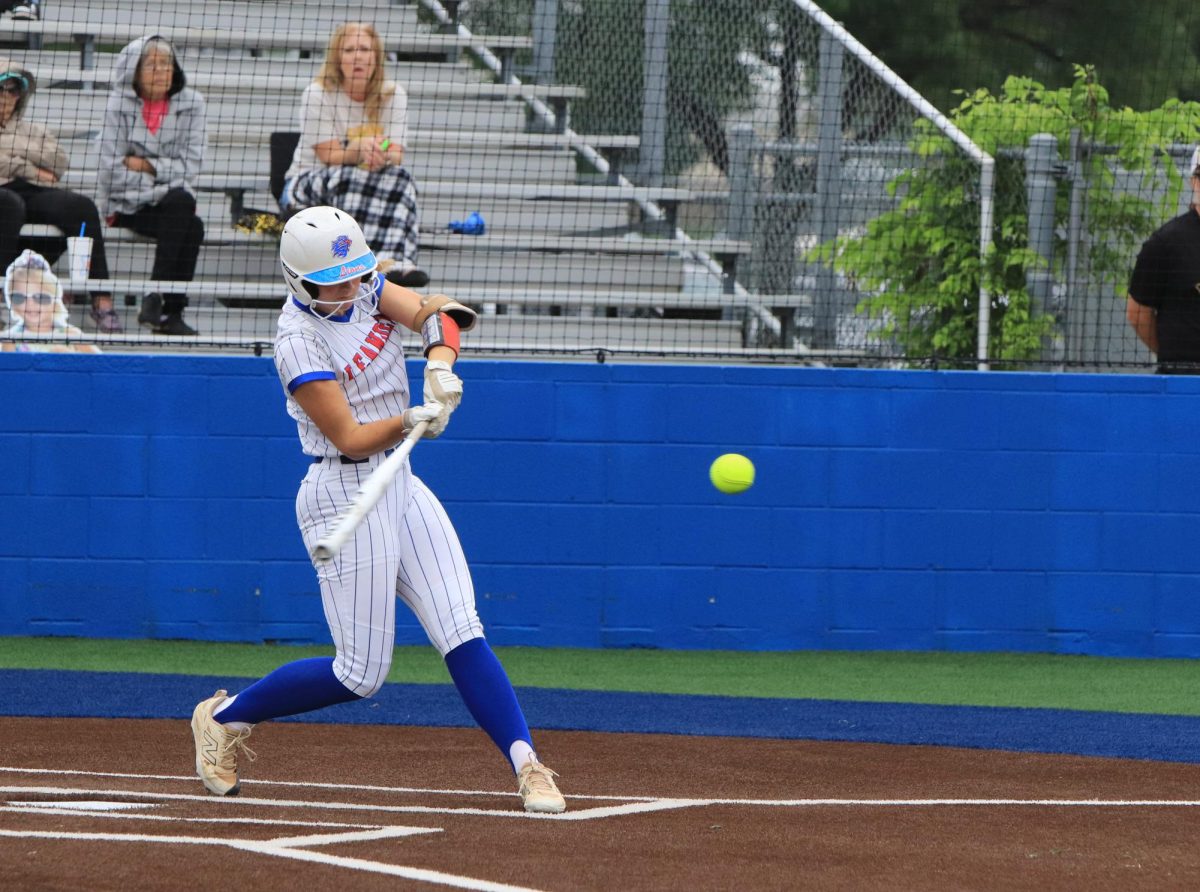 Senior Kylee Arnold keeps her eyes on the ball before getting a home run for Leander Softball. "Watching her hit the ball so far out of the park was like something I will never see again," sophomore Emery Ericson said.