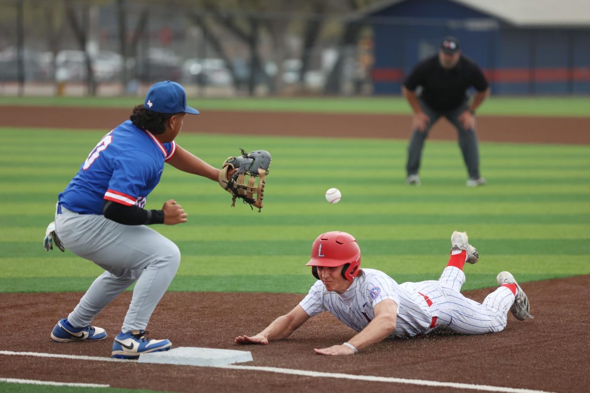Senior Tyler Moorman slides back into first base after an attempted  pickoff. Leander beat Temple 5-4 in the first game of the tournament on March. 5. 