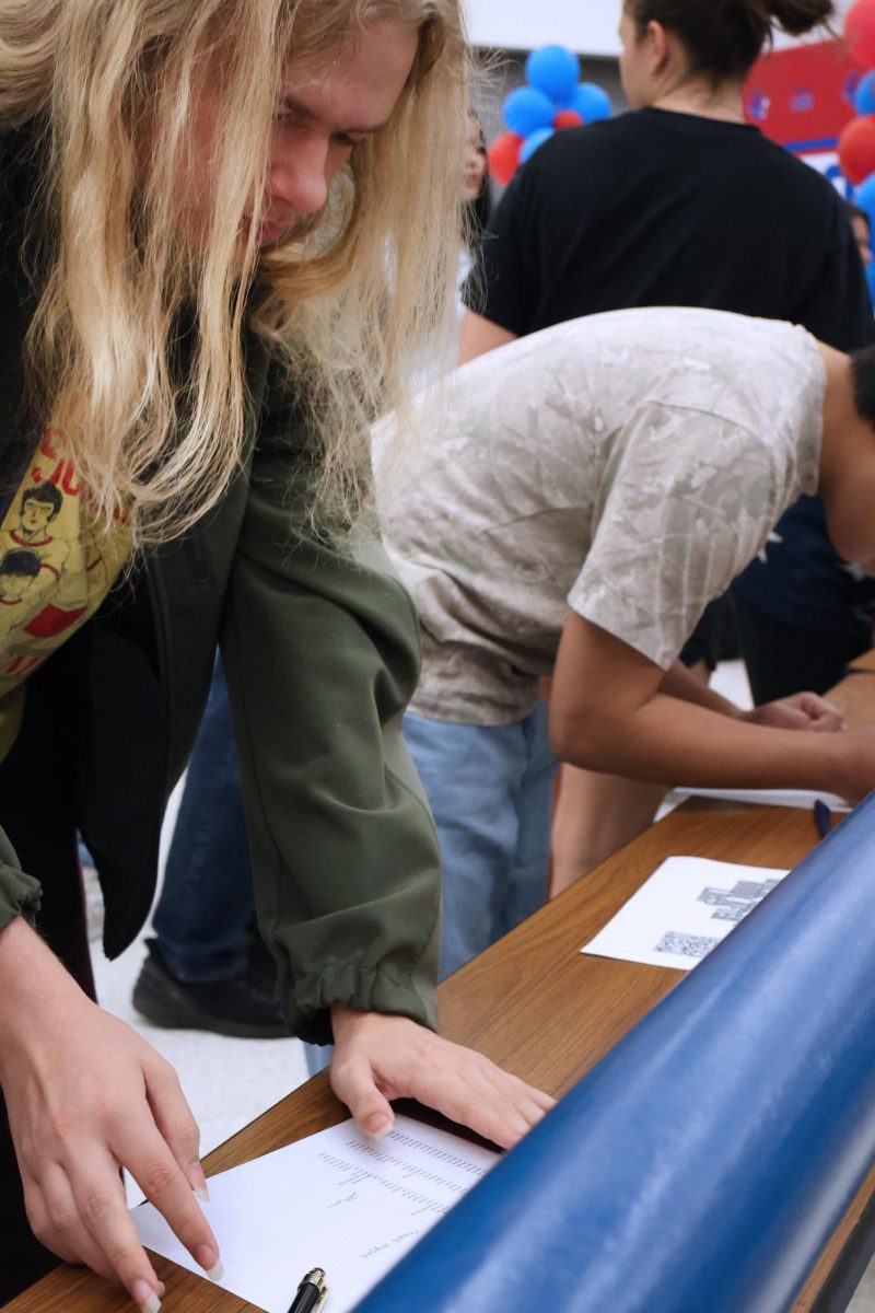 Ben Henke checks in at graduation practice Thursday morning. 