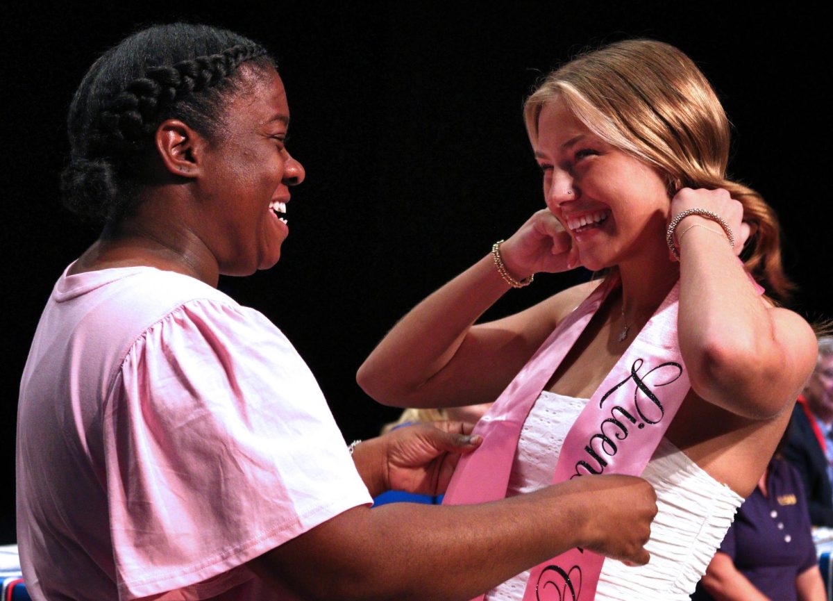Senior Romy Ford receives cosmetology sash at senior awards ceremony in the performing arts center May 20.