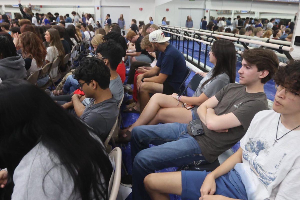 The last row of seniors, including William Westmoreland, waits for their names to be called at graduation practice Thursday.
