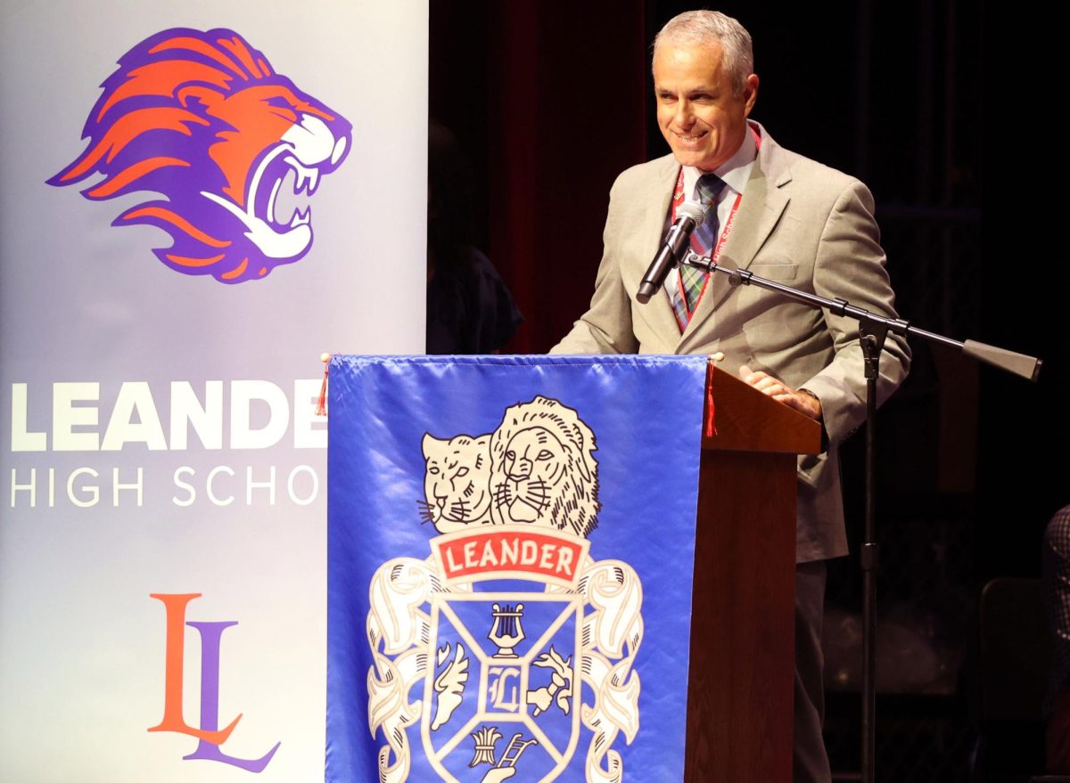 Principal Chris Simpson makes opening remarks, preparing to introduce senior Jay Coats for his speech May 20.