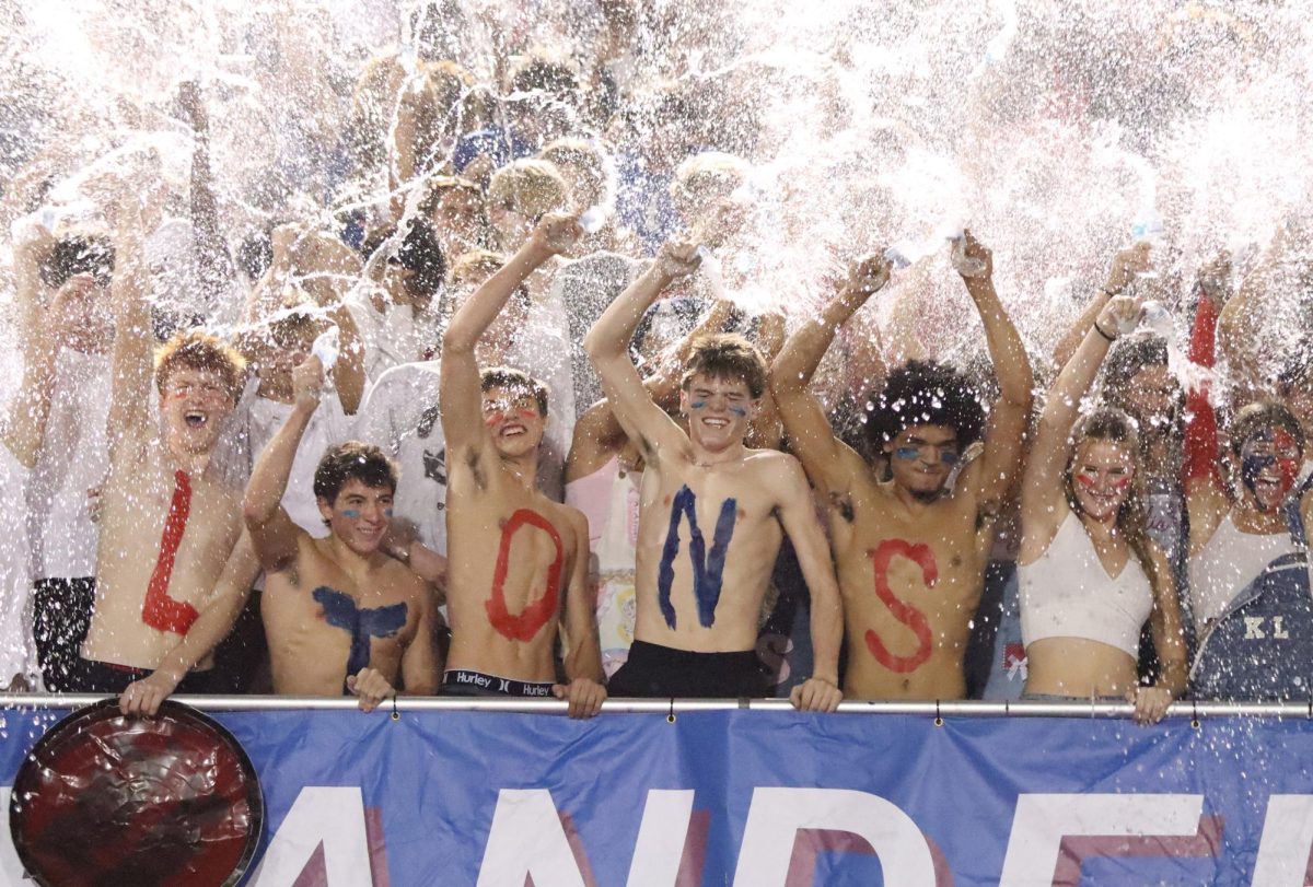 Senior Soren Leavitt, senior Tristen Votaw, junior Jackson Reisdorph, junior Benjamin Foronate, and senior Gavin Glover spraying water during a celebratory band played song called "Tear it up" after halftime during the homecoming game against Glenn at Bible Stadium Oct. 3. Rutschman secured her second first place win in the Photo of the Year competition with this photo.