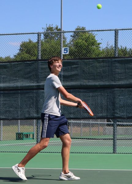 Junior Joshua Mann prepares to jump and hit the ball back to his opponent. 