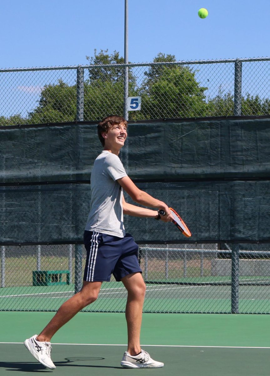 Junior Joshua Mann prepares to jump and hit the ball back to his opponent. 